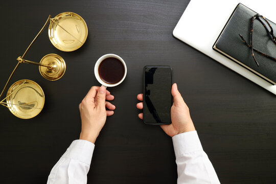 Business Workspace Flat Lay with Smartphone, Coffee Cup, and Legal Balance Scale