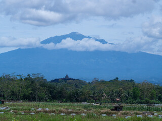 Aerial view of Borobudur Temple in Central Java, Indonesia, with Merapi volcano in the background. UNESCO World Heritage Site, culture, history, and travel themes © Wang