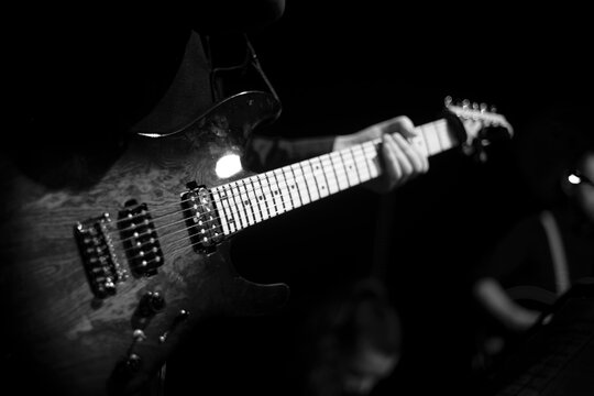 Silhouette of a guitarist at a concert.