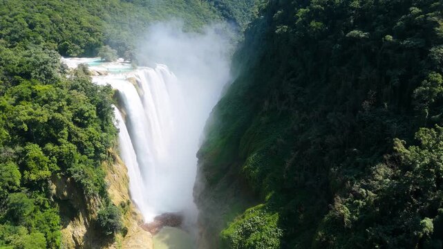 Waterfall at Cascada de Tamul in Huasteca Potosina creates mist and flows in a tropical setting