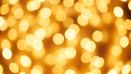 Obraz premium A warm and inviting abstract background filled with numerous soft, golden-orange bokeh light circles, creating a festive and dreamy atmosphere.