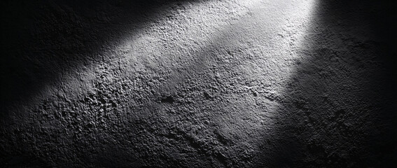 Fototapeta premium Close-up of textured concrete with dramatic light and shadow play.