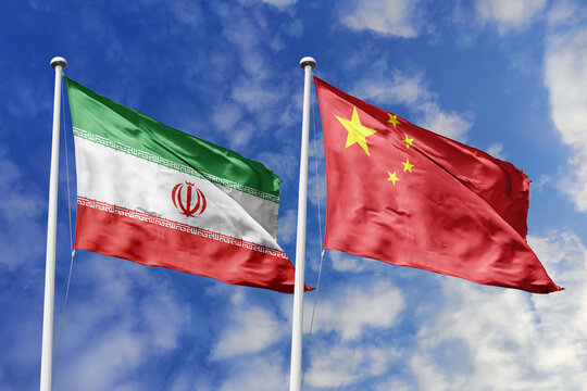 Iran and China National Flags Waving Together Against a Blue Cloudy Sky Symbolizing Diplomatic Relations, Middle Eastern Cooperation, Economic Partnership, Cultural Unity, and Shared History