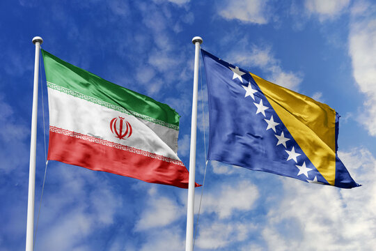 Iran and Bosnia and Herzegovina National Flags Waving Against a Cloudy Sky Symbolizing Diplomatic Relations, Middle Eastern Cooperation, Economic Partnership, Cultural Unity, and Shared History