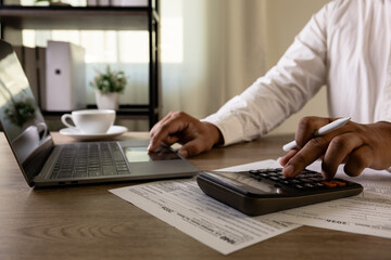 Accountant with US tax forms Accountant uses calculator tax papers falling review tax forms and...