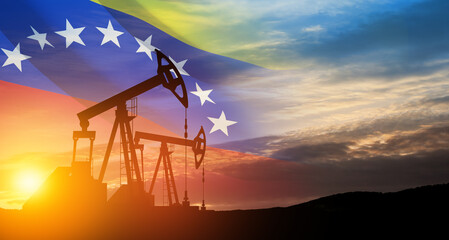 The change in oil prices. Oil price cap concept. Oil drilling derricks at desert oilfield with Venezuela flag. Crude oil production from the ground. Petroleum production.