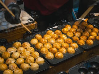 Takoyaki cooking on hot pan Japan Street food Osaka snack shop Japan Travel