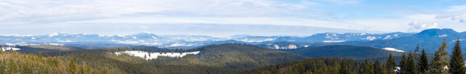 Panoramic landscape with forested slopes and snow-capped peaks of the Călimani Mountains - Romania at the end of winter © sebi_2569