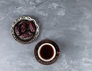 Dates and coffee on textured surface