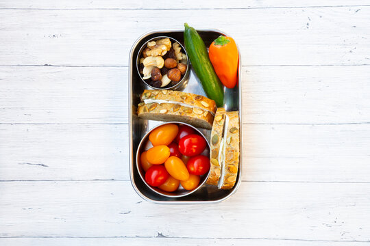 Healthy lunchbox with pumpkin seed bread vegetables and nuts