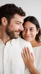 Obraz premium Engagement couple white attire diamond ring vertical. Woman hand showing jewelry embracing man, romantic wedding celebration. Love relationship happiness minimalist style gray background.
