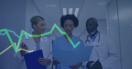 Reviewing patient folder, three staff in white coats, blue scrubs examining data chart in hallway © vectorfusionart