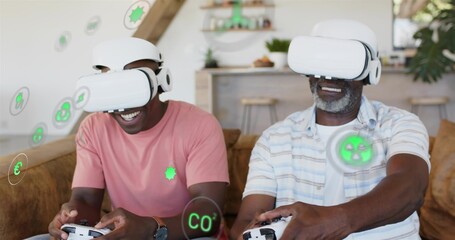 Obraz premium Playing duo wearing salmon and striped shirts at home, using white VR gear showing AR icons