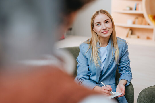 Businesswoman discussing with colleague in modern office setting