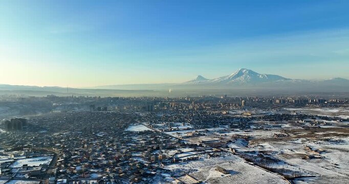 Aerial view A snowy Yerevan Armenia cityscape with a few houses and a few cars