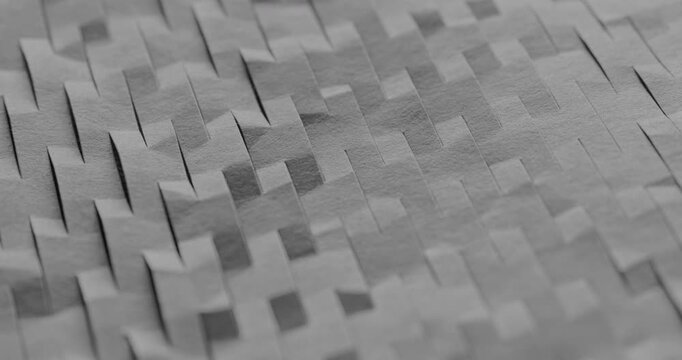 Gray Paper Strips Woven Texture. Slow panning footage across an intricate woven pattern of overlapping rectangular gray paper strips, revealing subtle depth and layered shadows.