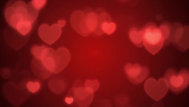 Dreamy red heart shapes gently blurred across a rich crimson backdrop, symbolizing love, passion, and romance, perfect for heartfelt designs and festive occasions