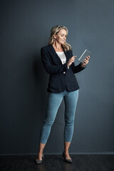 Businesswoman, research and reading in studio with tablet, admin and pride for human resources job....