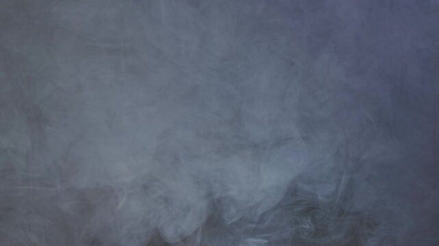 Blue Vapor on Dark Backdrop. Vapor emerging from shadows, forming transient shapes.