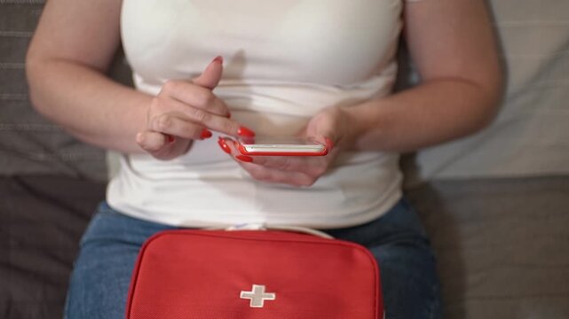 First aid kit. Typing a message. Message on a smartphone. Slow motion video. High quality 4k footage