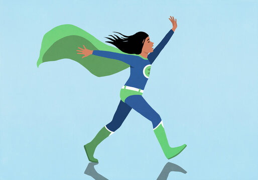 Carefree girl in superhero costume walking with arms outstretched