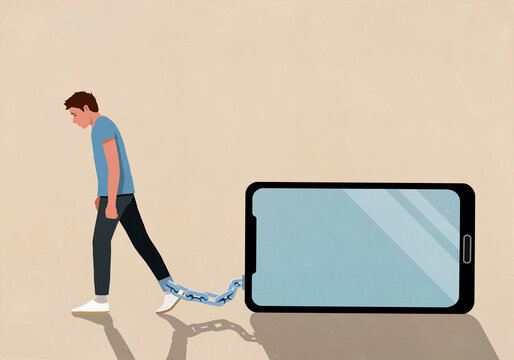 Man dragging large smart phone chained to his ankle on beige background