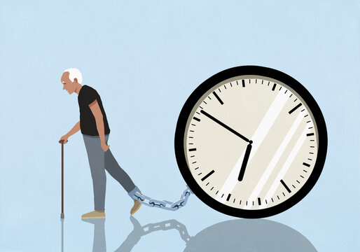Elderly man dragging large clock chained to his ankle against blue background