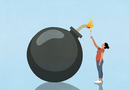Woman igniting large bomb with flame on blue background