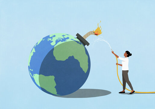 Woman trying to put out fire of lit fuse on large globe bomb