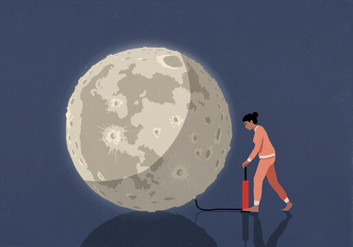Woman in pajamas inflating full moon with tire pump
