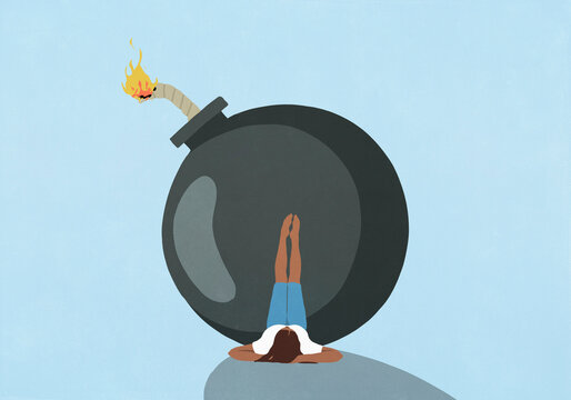 Woman laying with feet up on large bomb with lit fuse