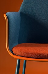 Modern chair showing blue fabric and orange trim