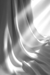Abstract grayscale fabric folds, textures, and light contrasts in a dark setting
