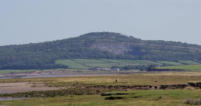 Wides shot looking up the Kent Estuary with Warton Crag limestone cliffs. Taken at Bolton le Sands, The shore car park.