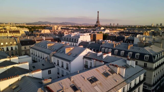 Aerial drone shot over Paris rooftops with Eiffel Tower in background, sunset lighting, cinematic movement, clean architecture.