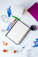 workplace in laboratory with blank open notebook top view