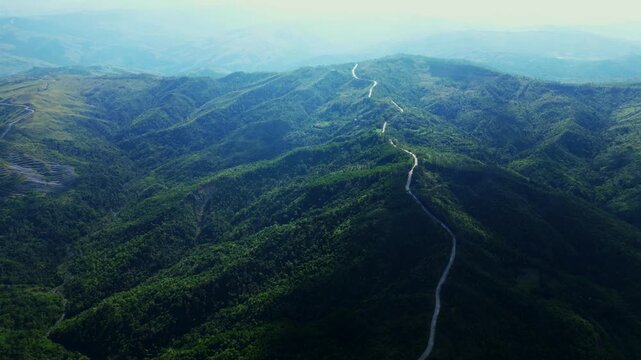 Top-down aerial showcasing Daang Katutubo&rsquo;s winding road patterns cutting through natural mountain terrain.