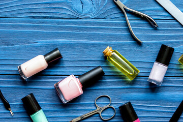 nail polish and manicure set on dark wooden background