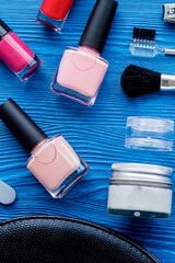 cosmetic and manicure set on wooden background top view