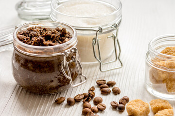 homemade coffe scrub in glass jar on wooden background