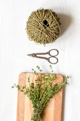 fresh herbs preparation to be dried top view wooden background