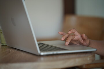 Close-up of hands typing on a laptop keyboard, remote work or digital nomad lifestyle.