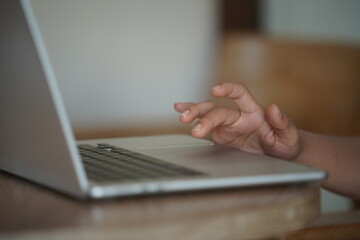 Close-up of hands typing on a laptop keyboard, remote work or digital nomad lifestyle.