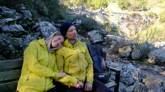 Young travelers discover ancient amphitheater and ruins of Termessos. Walking, climbing, enjoying view and ancient history in warm Turkish light.