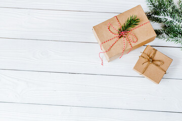 gifts boxes with fir branches on wooden background top view