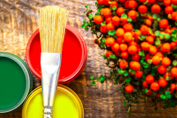 paint cans with brush on a wooden background top view