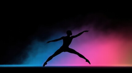 Obraz premium A dancer in silhouette performing a dynamic pose on a stage with a gradient background.