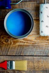 concept preparation for painting with  can of blue paint