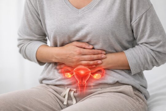 Woman holding abdomen with highlighted uterus health concept. Pelvic pain highlighted by glowing uterus, ovary anatomy.  causes of pain period cramps, endometriosis
