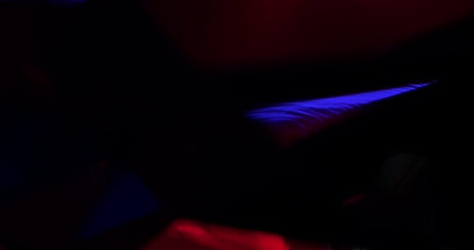 Abstract Red-Blue Geometric Light Play Seamless Loop. Dynamic interplay of vibrant crimson and cobalt triangular facets with shifting glows and reflections in motion.